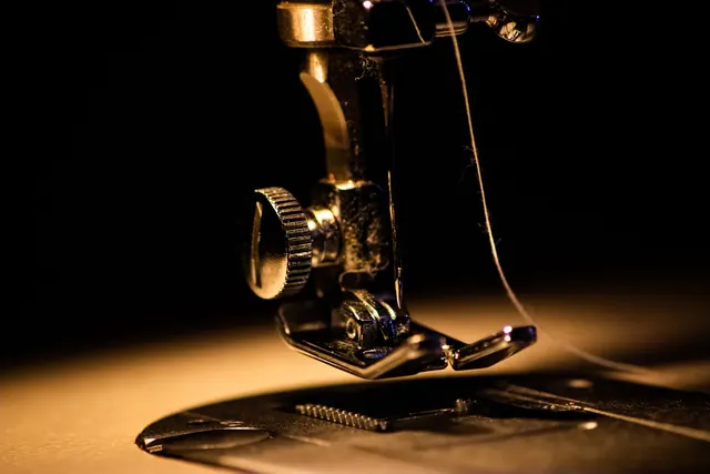 Detailed close-up image of a sewing machine with a threaded needle, perfect for textile and crafting themes. Sewing machine restoration mistakes: lessons and fixes
