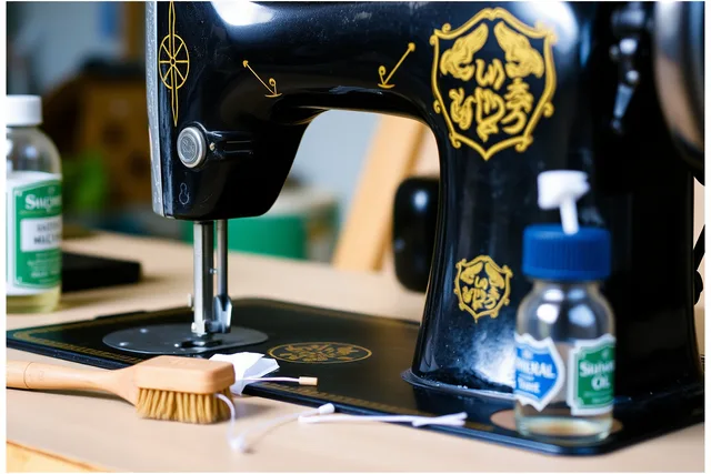 Vintage black sewing machine with gold decals being cleaned with brush and oil. 5 parts of beginner sewing machine restoration, explained